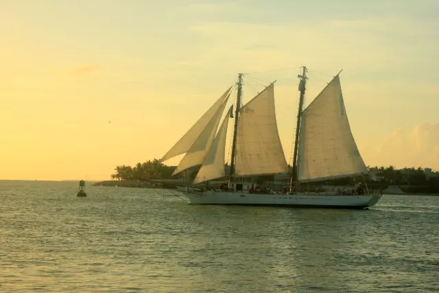 Large schooner under full sail in golden evening light off Key West